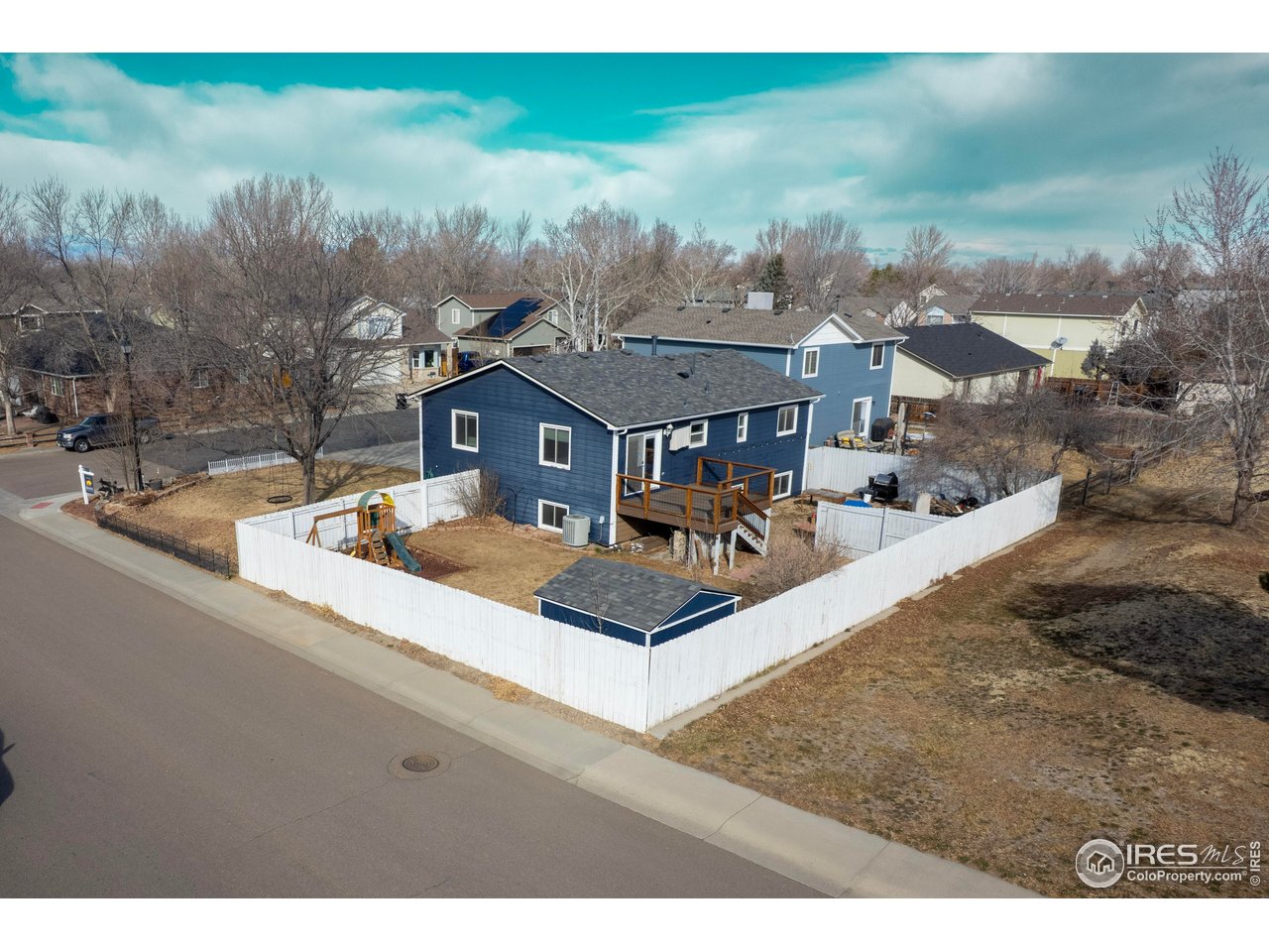 124 Adams Way Firestone, CO 80520 - Photo 32 of 34 a view of a house with a yard