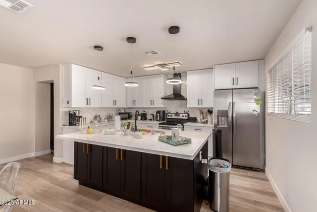 a kitchen with a sink a refrigerator a stove and cabinets