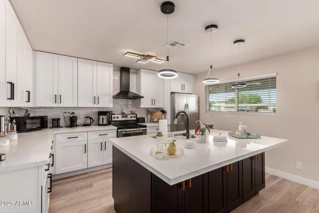 a kitchen with a sink a stove and cabinets