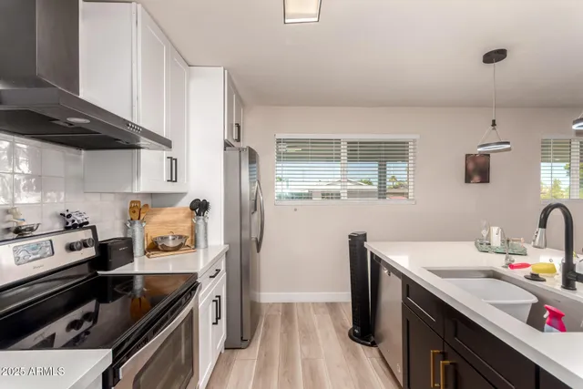 a kitchen with a sink stove and refrigerator