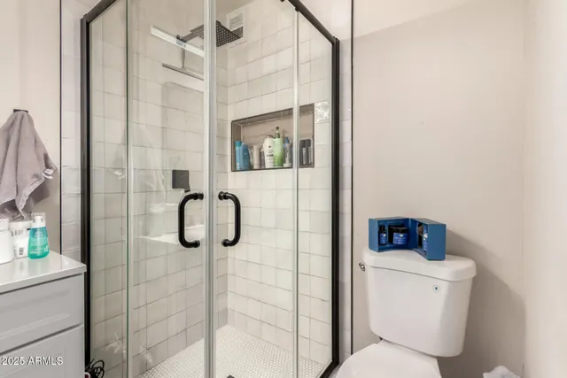 a bathroom with a toilet and shower