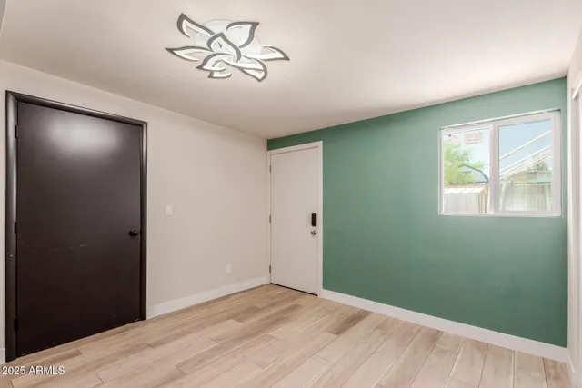 a view of room with window and wooden floor