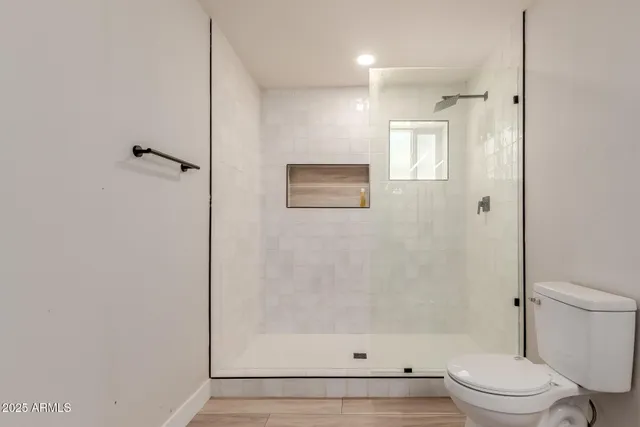 a bathroom with a shower a toilet and a shower