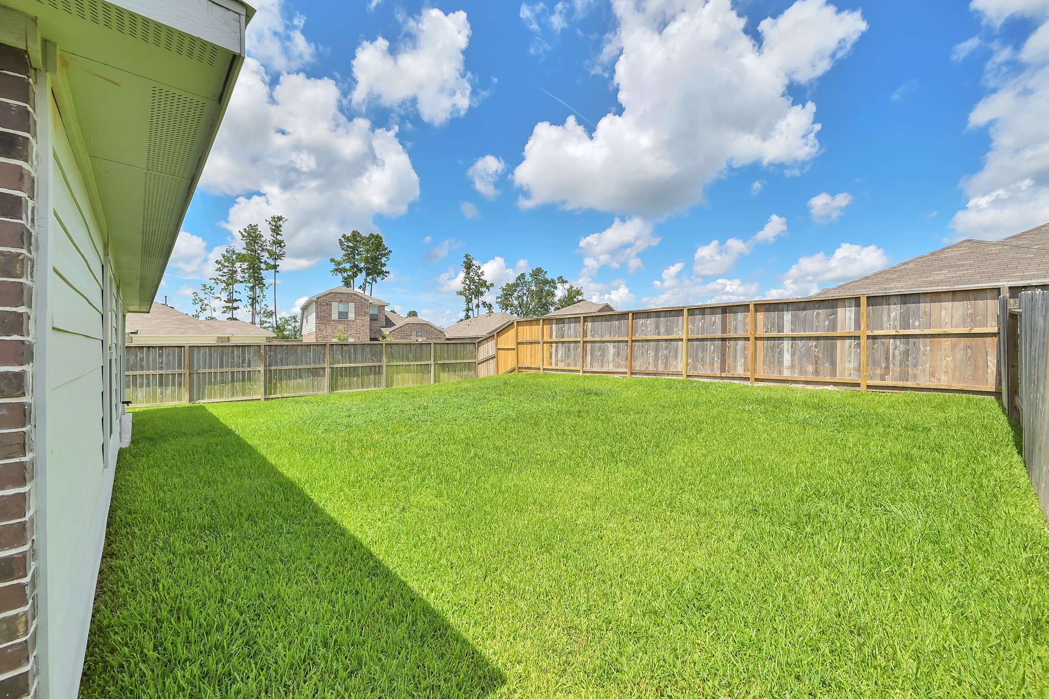 21391 Owl Road New Caney, TX 77357 - Photo 13 of 13 a view of yard with swimming pool and green space