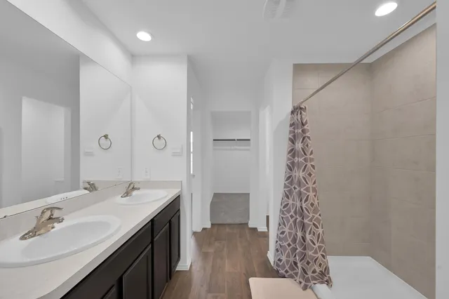 a spacious bathroom with a sink and a mirror