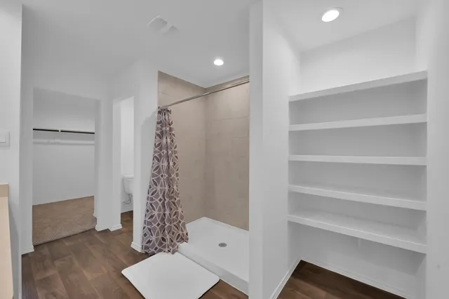 a bathroom with a shower a toilet and a sink