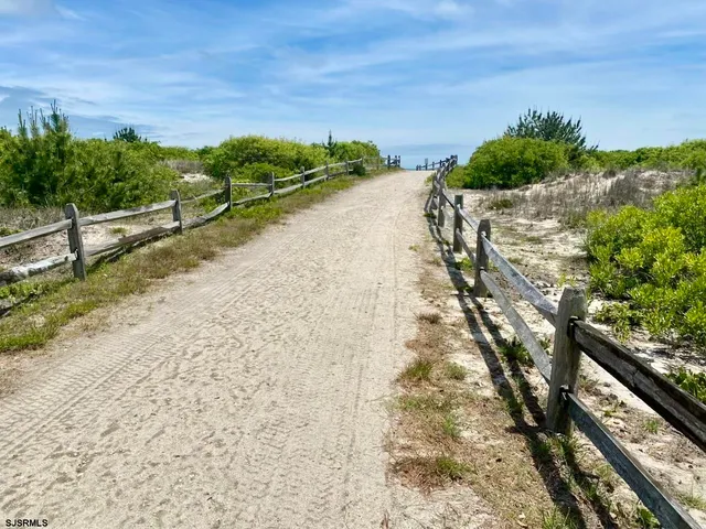 a view of a yard with wooden fence