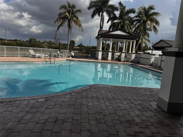 a view of a swimming pool with a table and chairs