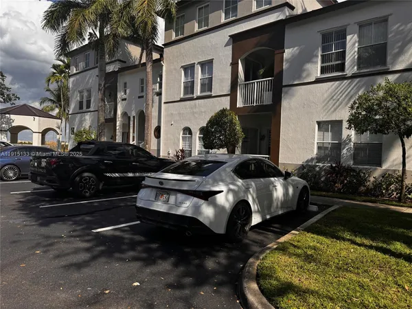 a couple of cars parked in front of a house