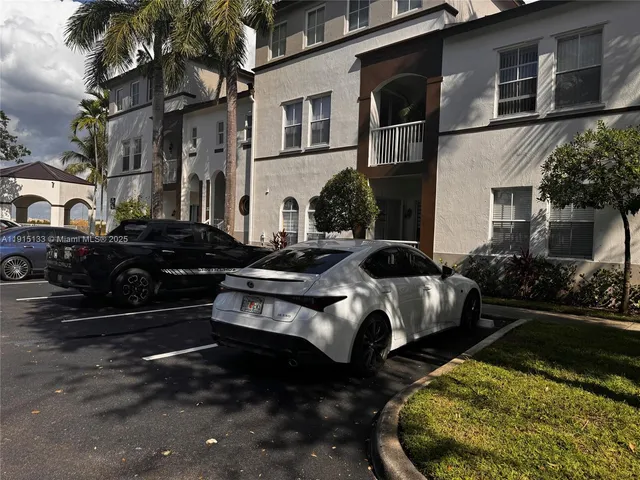 a couple of cars parked in front of a house