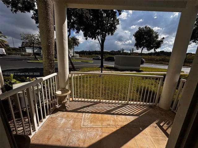 a view of a balcony with wooden floor