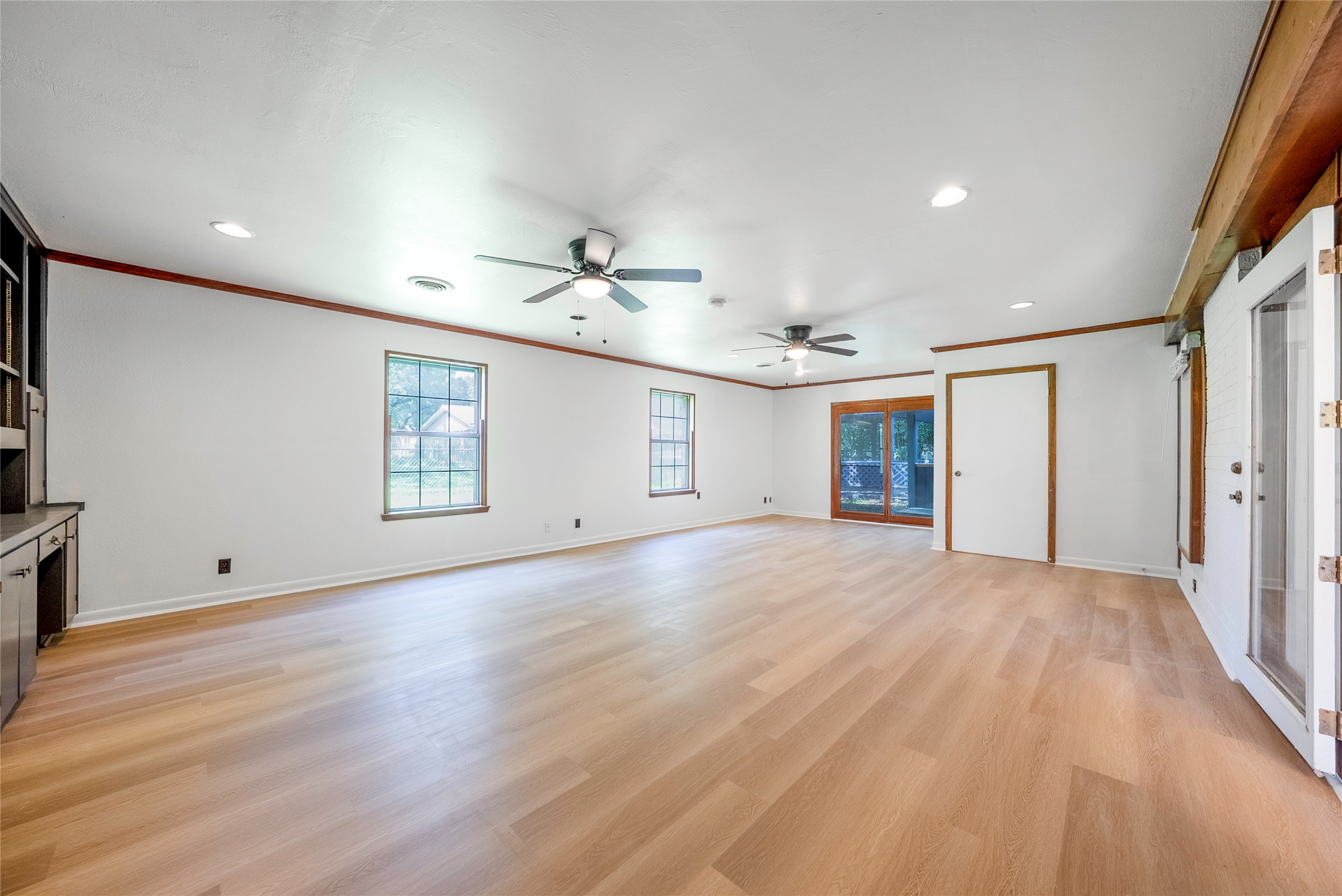 807 Country Club Road Georgetown, TX 78628 - Photo 12 of 28 a view of an empty room with wooden floor and a window