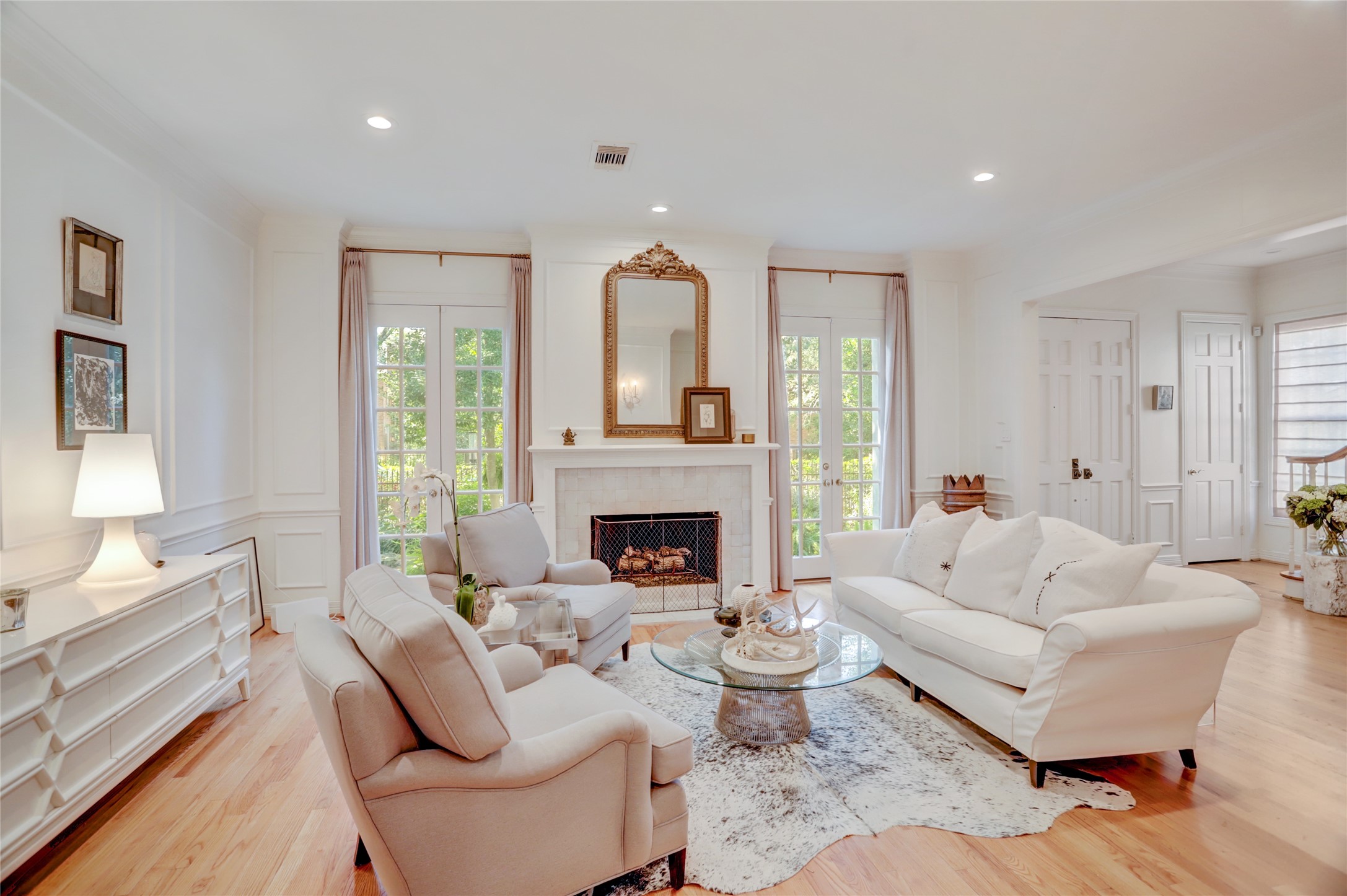 a living room with furniture a fireplace and a large window