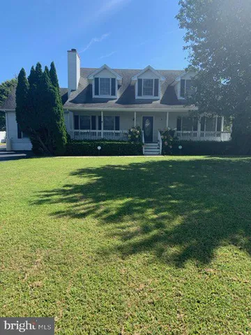 a front view of a house with a yard table and chairs