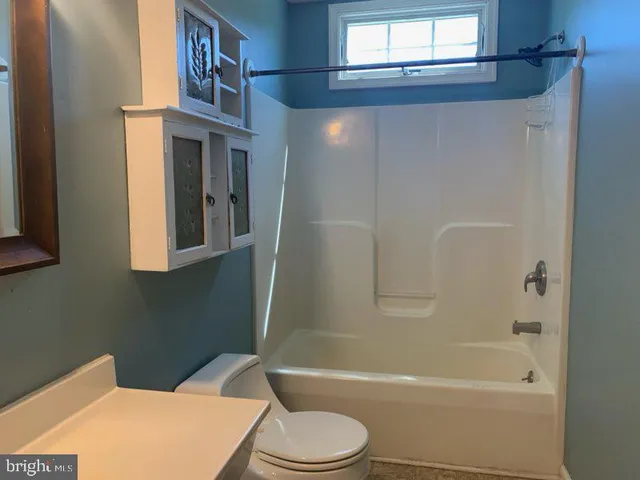 a bathroom with a toilet a sink and bathtub