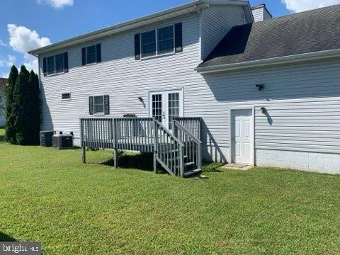 a view of backyard with a garden and deck
