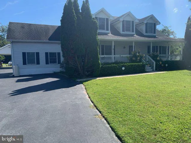 a view of a house with a yard and plants