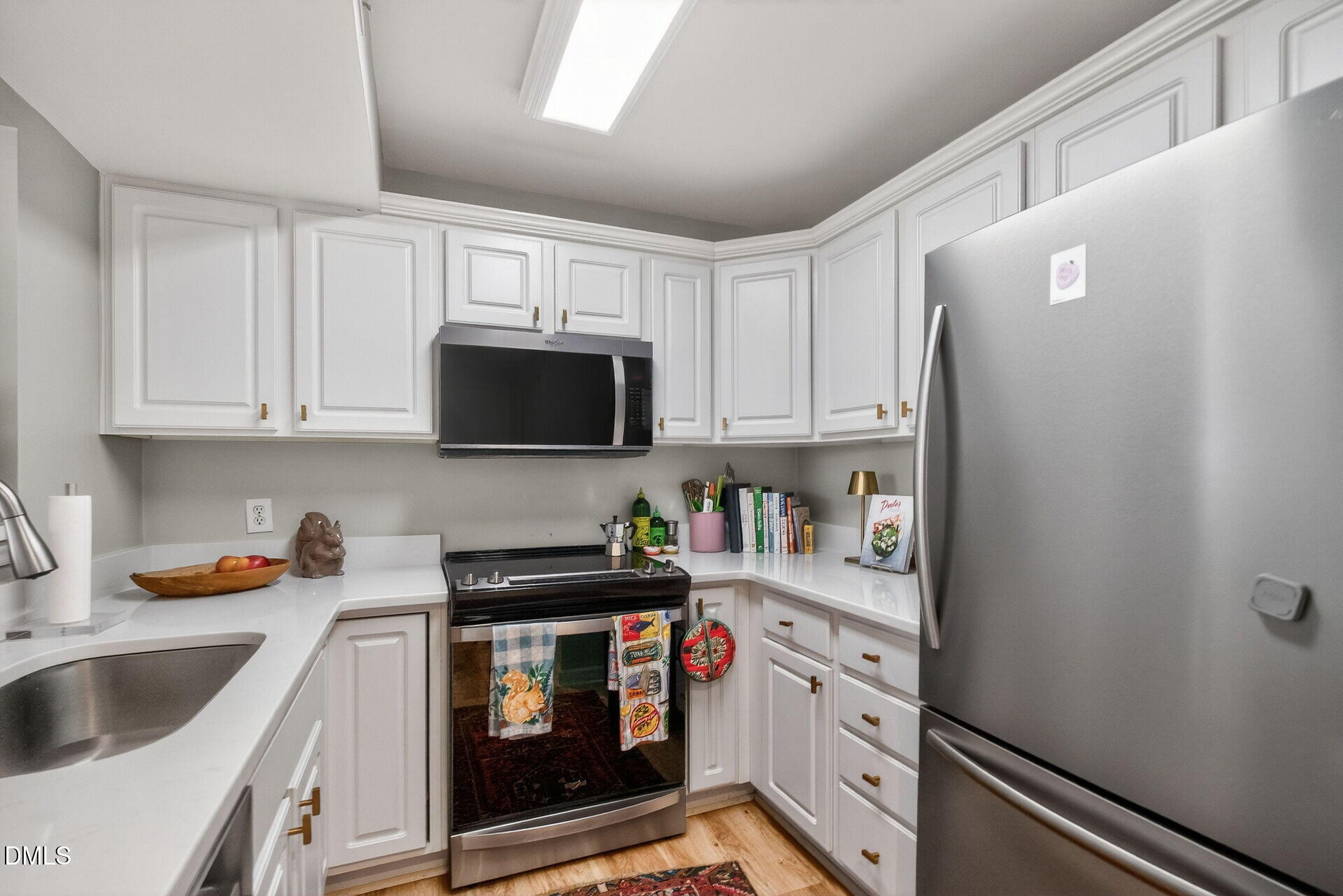 1111 Parkridge Lane, Unit 103 Raleigh, NC 27605 - Photo 13 of 24 a kitchen with stainless steel appliances a white stove top oven and cabinets