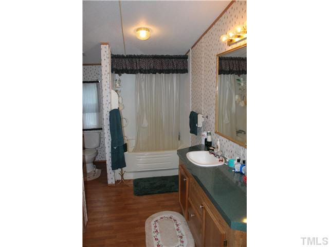 6117 Virgilina Road Roxboro, NC 27574 - Photo 18 of 19 a bathroom with a sink and a mirror