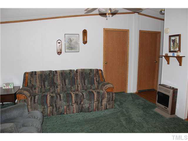 6117 Virgilina Road Roxboro, NC 27574 - Photo 8 of 19 a living room with a couch and a flat screen tv