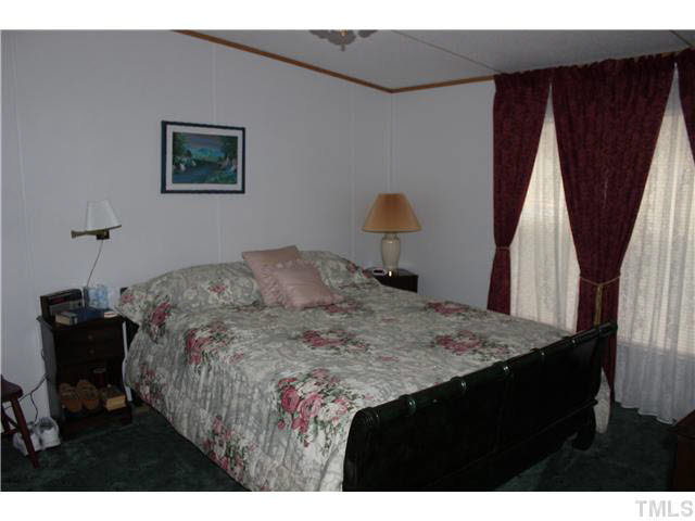 6117 Virgilina Road Roxboro, NC 27574 - Photo 9 of 19 a bedroom with a bed and a dresser