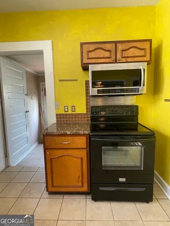 a stove top oven sitting inside of a kitchen