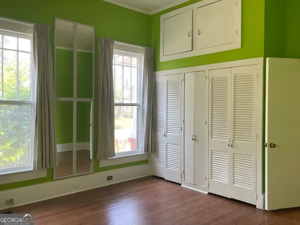 an entryway with wooden floor and windows