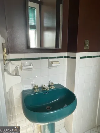 a bathroom with a sink and mirror