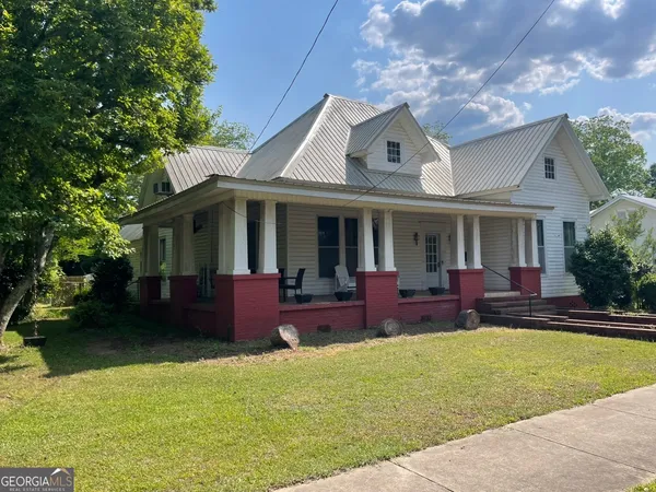 a front view of house with yard and outdoor seating