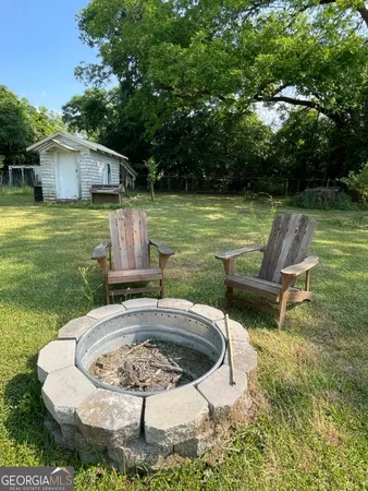a swimming pool with outdoor seating and yard
