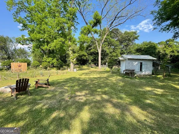 a backyard of a house with table and chairs