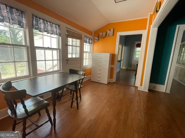 a view of a dining room with furniture and wooden floor