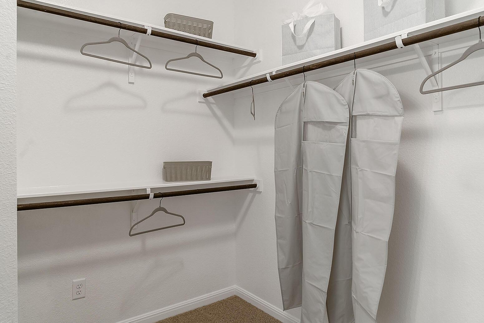 20603 B Combine Path Pflugerville, TX 78660 - Photo 16 of 19 Integrated shelving and rods offer organized storage solutions in this well-appointed closet space.