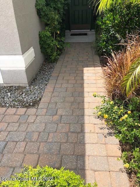 3312 Merrick Avenue Rockledge, FL 32955 - Photo 2 of 30 a view of a pathway with flower plants