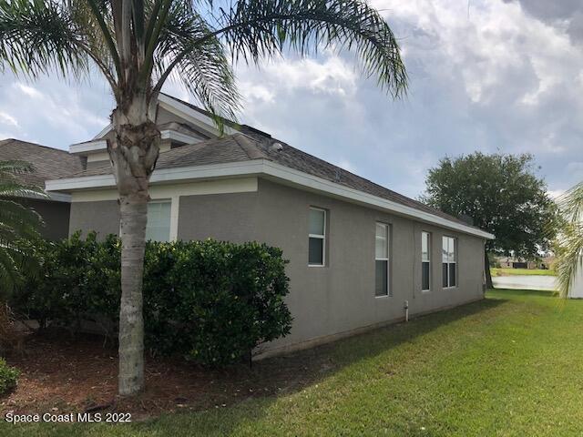 3312 Merrick Avenue Rockledge, FL 32955 - Photo 25 of 30 a front view of house with yard and green space