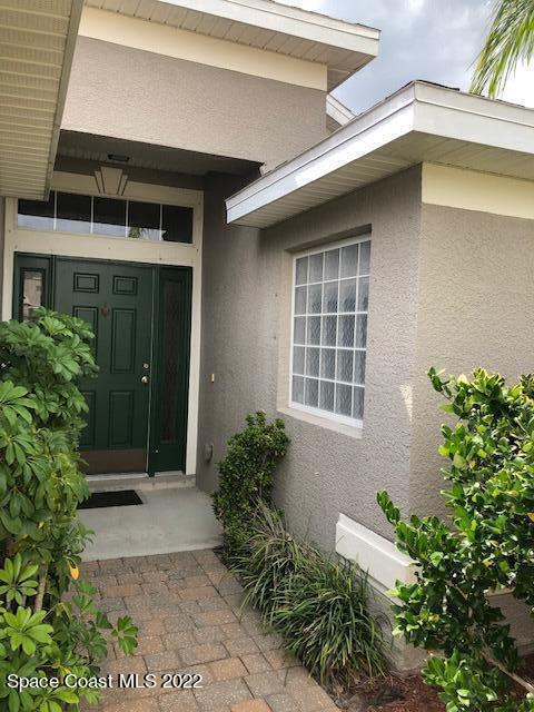 3312 Merrick Avenue Rockledge, FL 32955 - Photo 3 of 30 a front view of a house with a yard