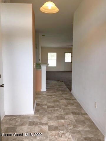 3312 Merrick Avenue Rockledge, FL 32955 - Photo 5 of 30 a view of a hallway with wooden floor