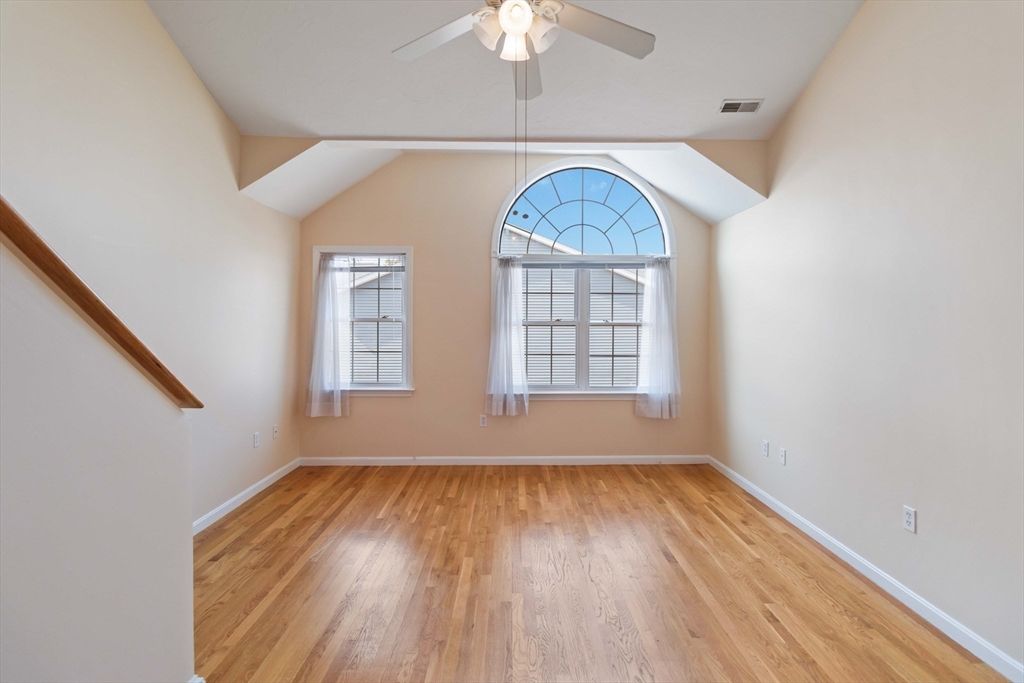 47 Alder Street, Unit 6 Waltham, MA 02453 - Photo 19 of 34 an empty room with wooden floor chandelier and windows