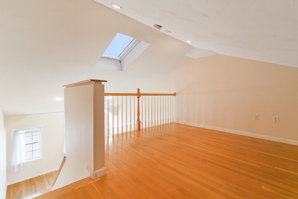47 Alder Street, Unit 6 Waltham, MA 02453 - Photo 31 of 34 a view of an empty room with wooden floor