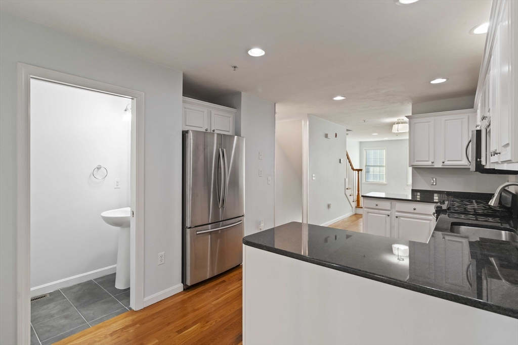 47 Alder Street, Unit 6 Waltham, MA 02453 - Photo 6 of 34 a kitchen with stainless steel appliances granite countertop a refrigerator a stove and a sink