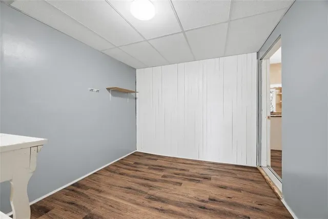 a view of empty room with wooden floor