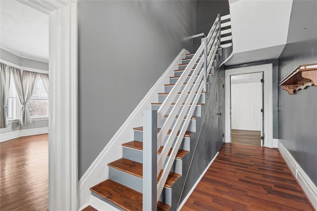 901 4th Avenue Freedom, PA 15042 - Photo 3 of 49 a view of staircase with lots of frames on wall and wooden floor