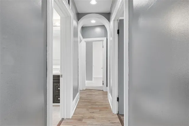 a view of a hallway with wooden floor and entryway