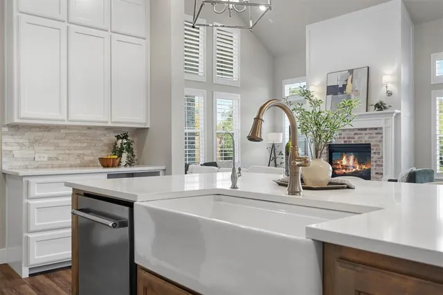 a kitchen with a sink cabinets and a fireplace