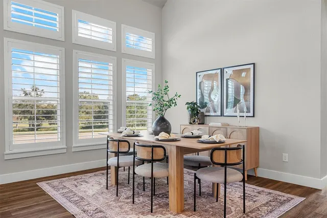 a dining room with furniture and wooden floor
