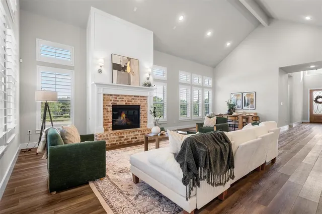a living room with furniture fireplace and window