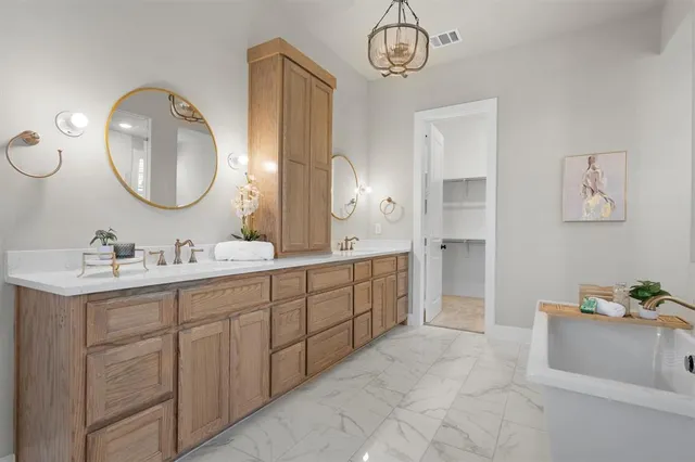 a spacious bathroom with a double vanity sink and a mirror