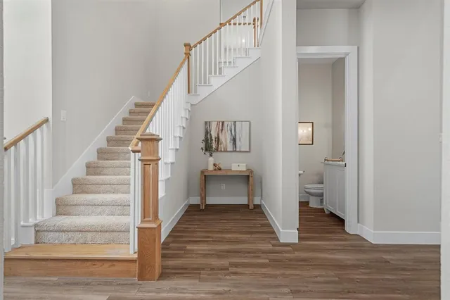 a view of entryway and hall with wooden floor