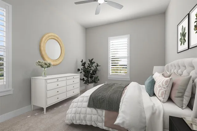 a bedroom with a bed and a chandelier fan