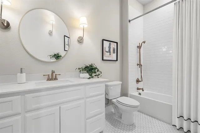 a bathroom with a granite countertop sink toilet a large mirror a vanity and shower
